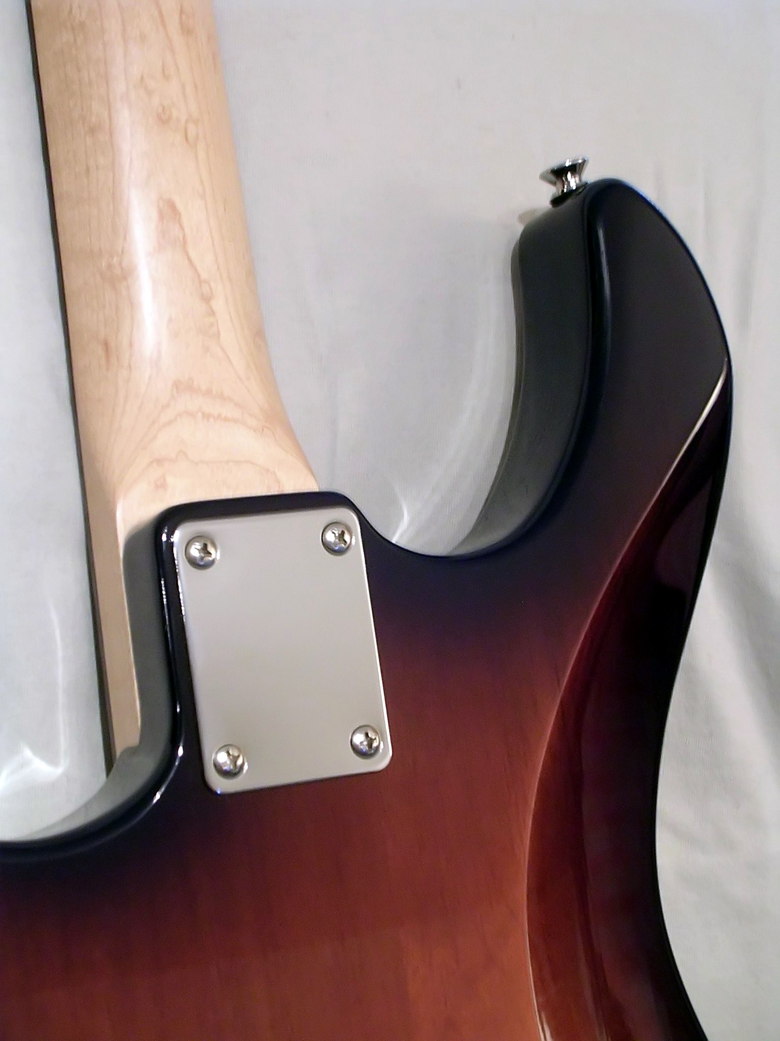 Bolt-on neck joint with four-screw plate on a Yamaha Pacifica 112 electric guitar